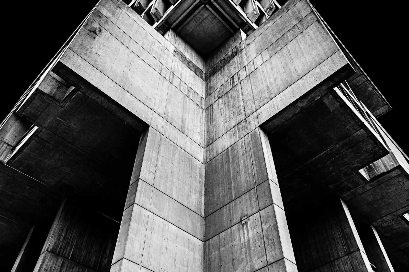 Intersecting concrete planes photographed in black and white.