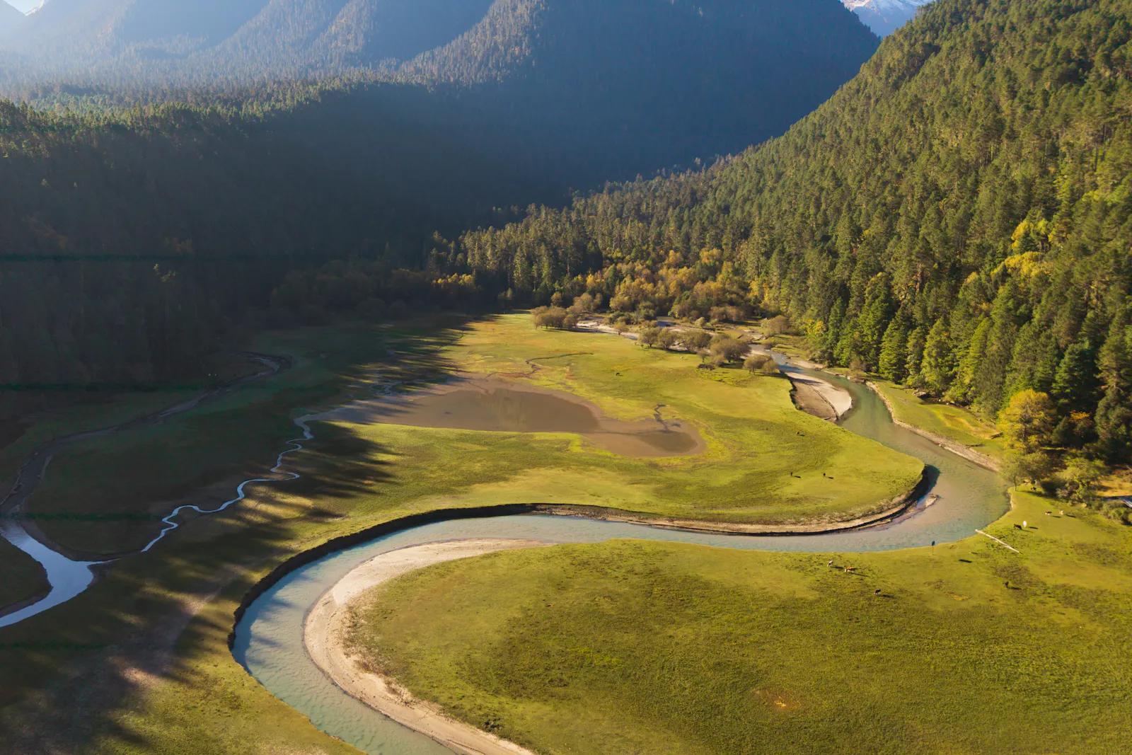 A river bending through a green mountain valley.