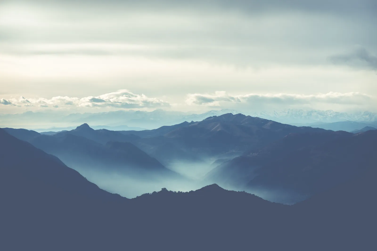 Clouds drifting through a mountain range.