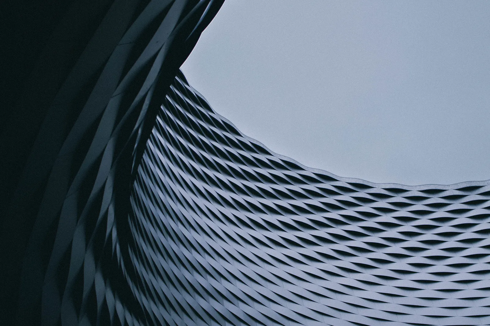 A curved facade with a repeating diamond pattern.