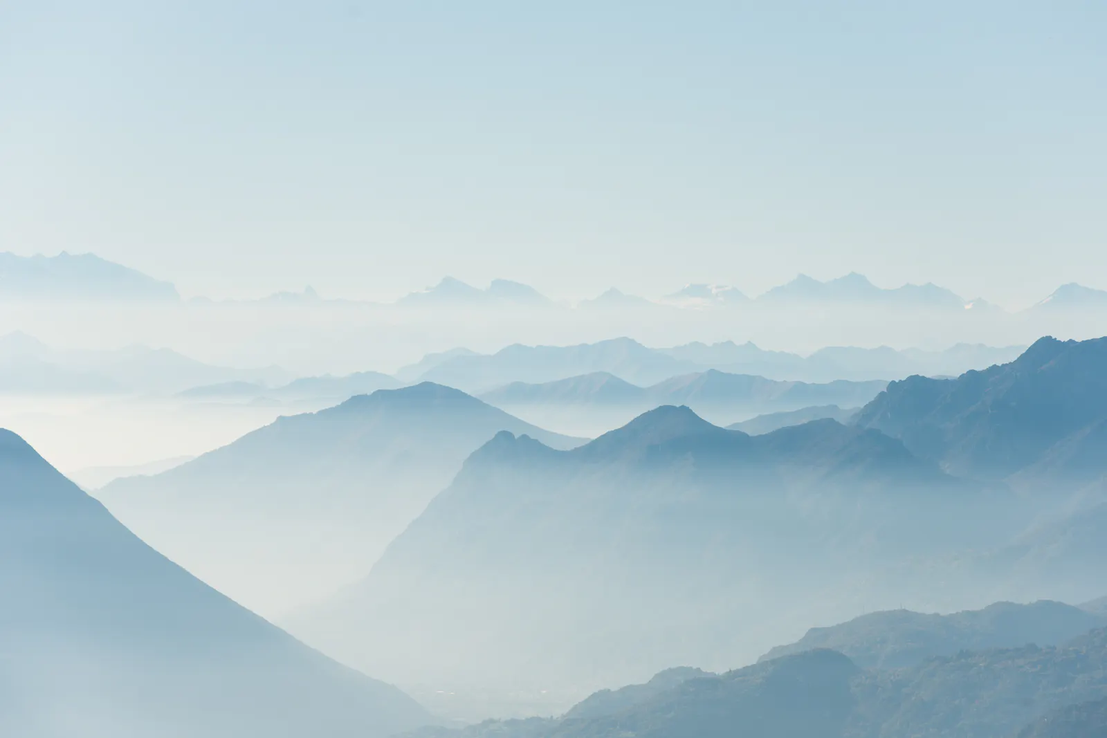 Pale mountain ridges receding into haze.