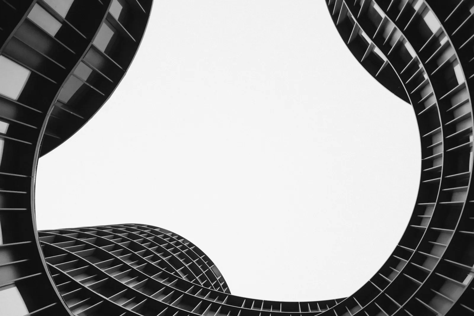 Curved building facades surrounding an open sky.