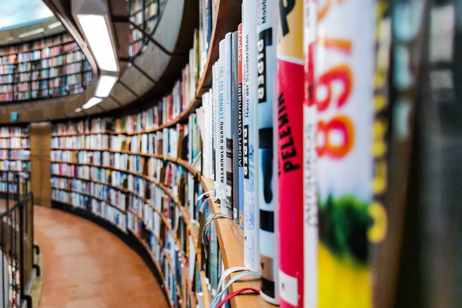 Curving library shelves filled with books.